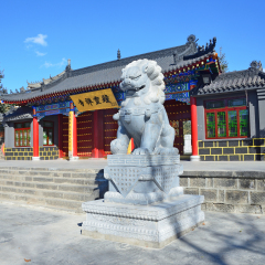 Wudalianchi, China. Sculpture of the mythological lion in front of the entrance to the temple  Zhongling  on the top of extinct Yaoquan volcano