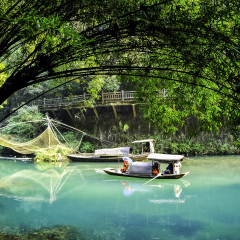 Geisha girl sitting on small boat at Three Gorges Tribe scenic spot