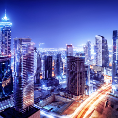 Dubai downtown night scene, UAE, beautiful modern buildings, bright glowing lights, luxurious travel and tourism 
