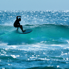 SURFERS PARADISE, AUS - OCT 14 2014: Surfer surfing in Main beach.It's a very popular surfing beach in Surfers Paradise Gold Coast Queensland, Australia.