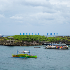 Panorama of Crystal Cove small island and tourist boats near Boracay island in the Philippines. August 2018