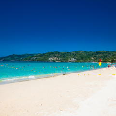Tourists at Patong beach in Phuket, Thailand. Phuket is a popular destination famous for its beaches.