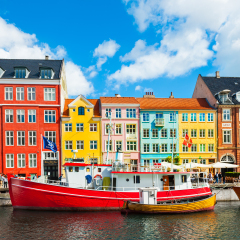 Copenhagen, Denmark - August 13, 2017. Famous Nyhavn pier with colorful buildings and boats in Copenhagen, Denmark