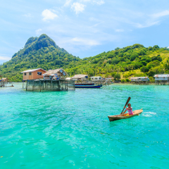 SABAH, MALAYSIA - APR 23, 2017: Unidentified Borneo Sea Gypsy kids on a canoes in Bodgaya Island in Tun Sakaran marine park, Sabah Borneo, Malaysia.