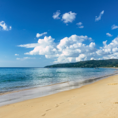Beautiful sea view on Karon beach, Phuket, Thailand, Asia. Famous Karon beach landscape, Phuket. Sunny beach. Beautiful white sand sea shore and calm sea in Phuket, Thailand. Endless sandy coastline. 