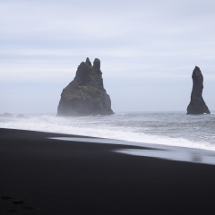 Stormy, moody day on black sand beach Reynisfjara on the south of Iceland, Europe, huge waves on Atlantic Ocean