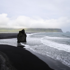 Stormy, moody day on black sand beach Reynisfjara on the south of Iceland, Europe, huge waves on Atlantic Ocean