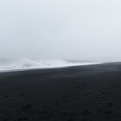 The waves hitting the beach at Black Sand Beach or Reynisfjara in Iceland
