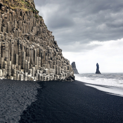 The black sand beach of Reynisfjara and the mount Reynisfjall from the Dyrholaey promontory in the southern coast of Iceland.