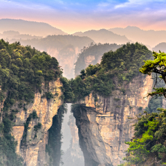 Zhangjiajie Forest Park at sunrise. Natural bridge connecting two mountain columns.
