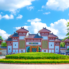 Buddhist Centre in the open air. in the Park of culture and religion. high gate into the Park and beautiful flowerbeds on a sunny day. Sanya.