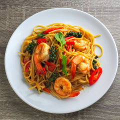  spaghetti stir fried spicy thai pad ki mao on white dish wood background  
