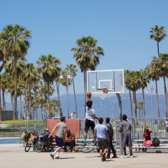 VENICE, CALIFORNIA - April 20, 2017: An group of unknown men playing basketball on an outdoor court in Venice Beach, California.