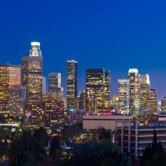 Los Angeles skyline at night with blue night sky.