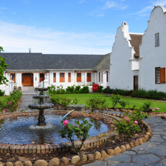 Stellenbosch, South Africa, September 2015. Beautiful green garden with fountain near Burgerhuis Museum