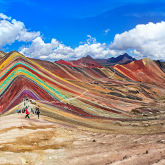 Unidentified  tourists walking on the Rainbow Mountain (Vinicunca Montana de Siete Colores - Spanish) in Cusco, Peru.