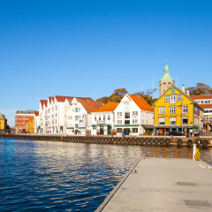 STAVANGER, NORWAY - OCTOBER 14, 2016: People at the quay port with many restaurants and pubs in the city centre of Stavanger. Stavanger is one of most famous cruise travel destinations in Europe.