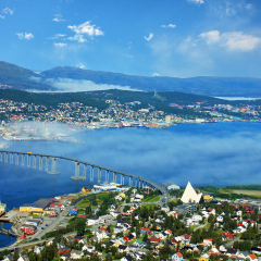 Bridge and panorama of city Tromso, Norway beyond the Arctic circle. View on mountains in Norwegian fjords