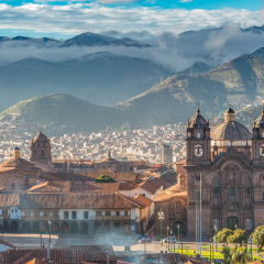 Morning sun rising at Plaza de armas with Adean Moutain and group of cloud, Cusco, Peru